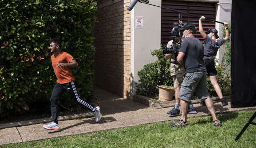 Arka Das, who acts in <i>Here Out West</i> and is one of the eight writers, runs from a unit block during filming.