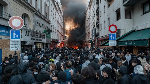 Protesters set up barricades and start fires near Place de la Republique in central Paris on Sunday.