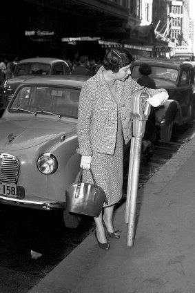 A Sydney motorist feeds the parking meter in Market Street, Sydney on  May 19, 1958. 