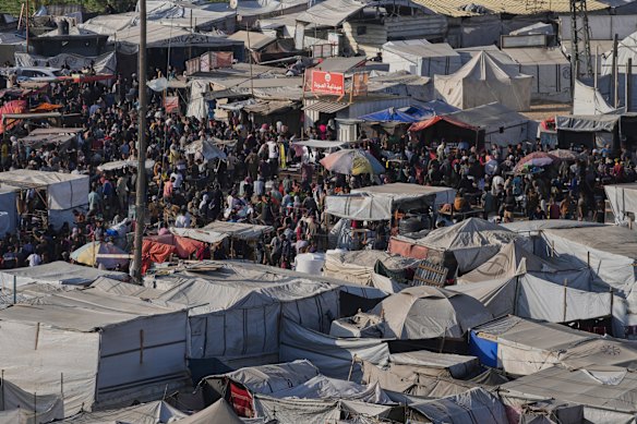 Displaced Palestinians walk through a makeshift tent camp in Khan Younis, Gaza, on Wednesday. 
