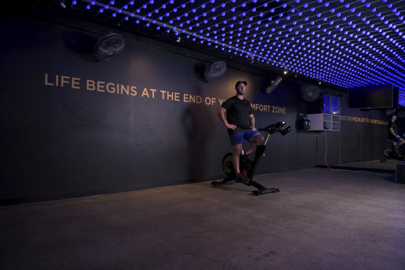 Flow Athletic's Ben Lucas pictured in an empty spin studio after lending his bikes to members to use at home.