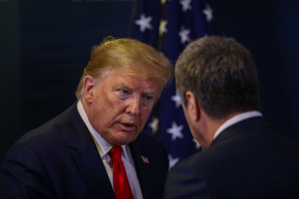 US President Donald Trump, left, speaks to Roberto Azevedo, director general of the WTO, in Davos.