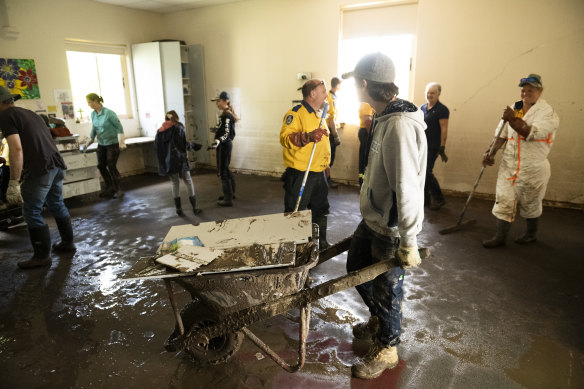 The cleanup begins at St Joseph’s Primary School in Eugowra after flash flooding destroyed the town on Monday.