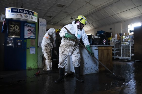 Fire and rescue crews from Lithgow, Wentworth Falls, Blackheath and Springwood clean out the Eugowra newsagency and supermarket after flooding destroyed the town.
