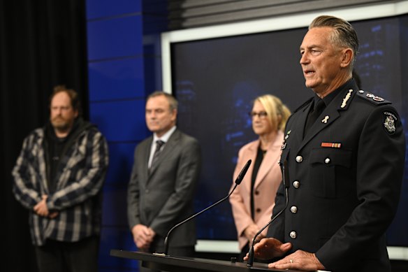 Victoria Police Chief Commissioner Mike Bush (right) and investigators on Monday.
