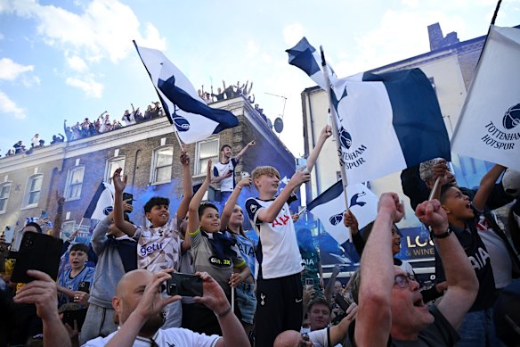 Tottenham Hotspur fans show their support as the bus arrives.