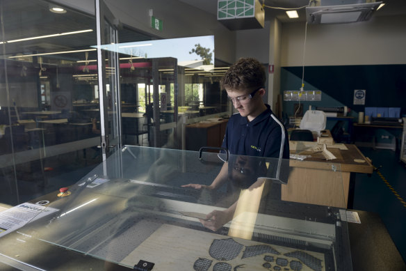 Year 10 student William O'Donnell with the laser-cutting machine at CathWest Innovation College.