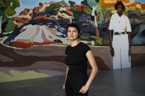 Thea Perkins besides her mural Stockwoman installed at Carriageworks for the Sydney Festival. 