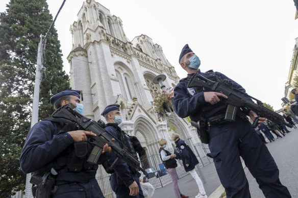 Police officers stand guard near Notre-Dame Basilica in Nice following the fatal attack.