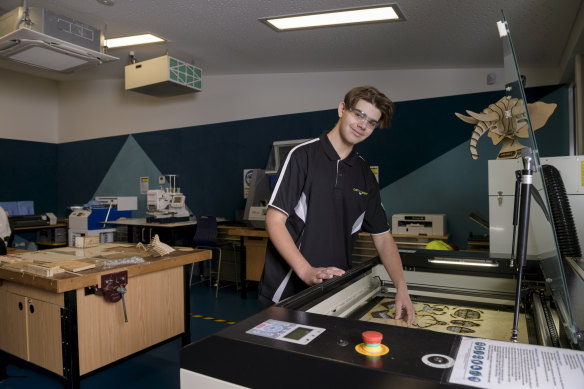 CathWest Innovation College  student Scott Drury with a laser-cutting machine that is helping him develop skills in advanced manufacturing.