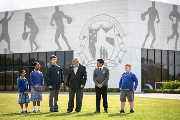 Lighthouse Christian College Cranbourne principal Jacob Mathews, pictured with students, says the school uses the Bible to teach its students to read English. 