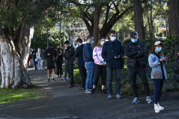 People queueing for a COVID test at a clinic on Beaconsfield Street in Alexandria.
