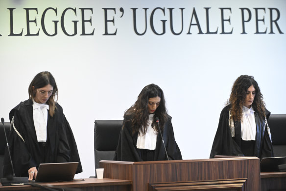 President of the court judge Brigida Cavasino, center, flanked by judges Claudia Caputo, left, and Germana Radice reads the verdicts of a maxi-trial of hundreds of people accused of membership in Italy’s ’Ndrangheta organised crime syndicate.