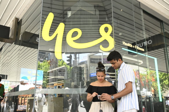 Ranish Kromodoyo and Anya Absalom struggle to make a call outside an Optus store.