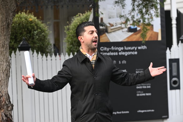 Village Real Estate auctioneer Joseph Luppino at the auction of 11 James Street, Seddon, on Saturday. 