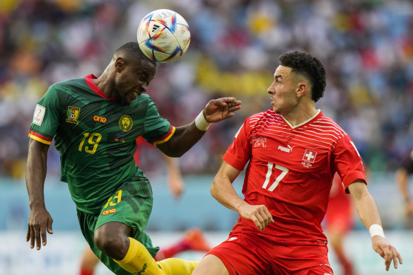 Cameroon’s Collins Fai, left, heads the ball next to Switzerland’s Ruben Vargas.