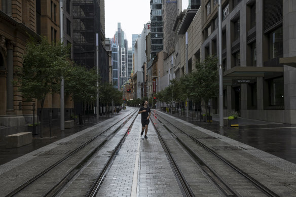 A runner follows the George St tram line on Friday.