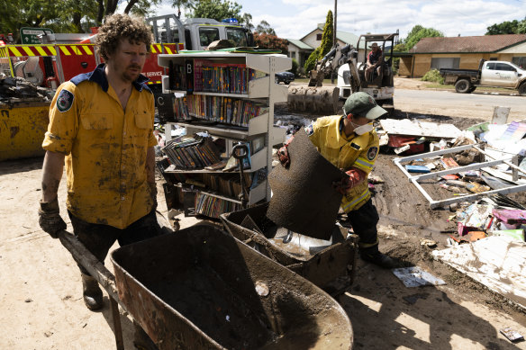 Rural Fire Service members aid the clean-up in Eugowra on Wednesday.