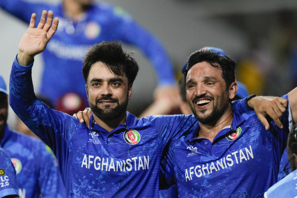 Afghanistan captain Rashid Khan (left) and teammate Gulbadin Naib celebrate after defeating Bangladesh.