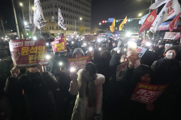 People gather at the National Assembly in Seoul to demand South Korean President Yoon Suk Yeol’s resignation.