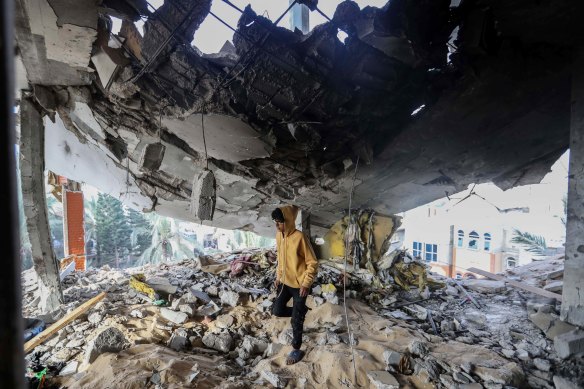 People inspect the damage to their homes following Israeli air strikes in Rafah.