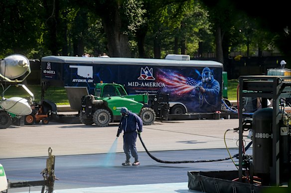 A worker applies the “American Flag blue” protective coating.