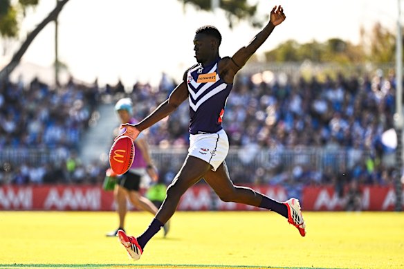 Michael Frederick of the Dockers kicks the ball.