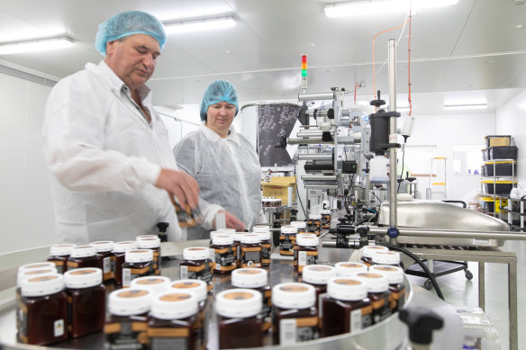 "The only winners are the lawyers": Nicola Charles and her husband Robbie bottling their honey.