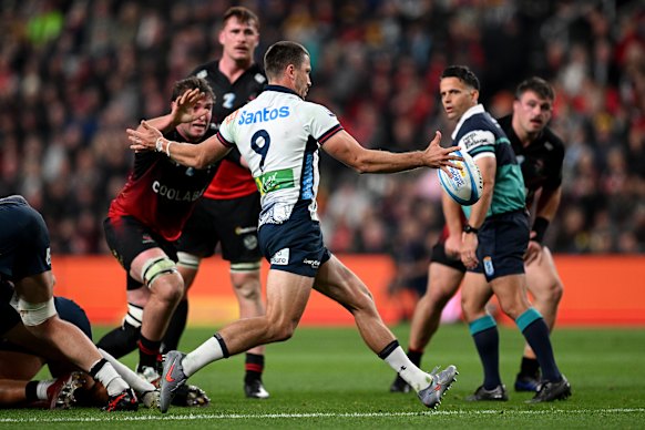 Waratahs halfback Jake Gordon gets a kick away during Super Round.