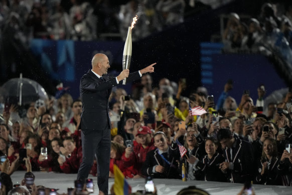 Zinedine Zidane, the football manager and former player known as Zizou, carries the torch.