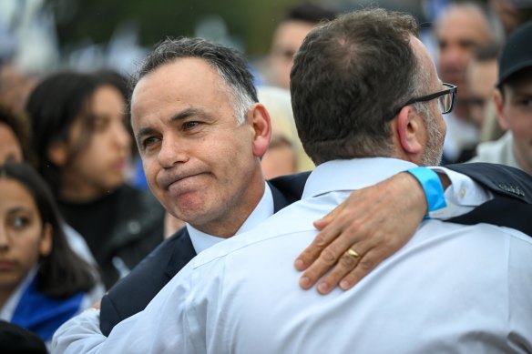Opposition Leader John Pesutto hugs a man at the vigil.