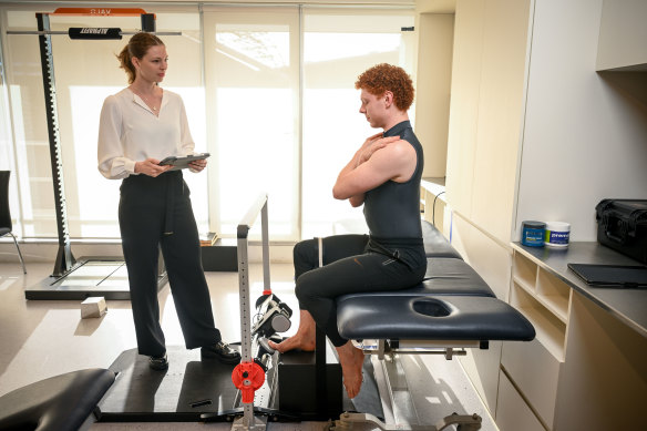 Brazilian PhD student Bruna Tessarin tests the calf strength of dancer Jacob De Groot.