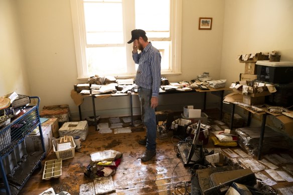 Eugowra Rural Transaction Centre committee member assesses the damage on Thursday.