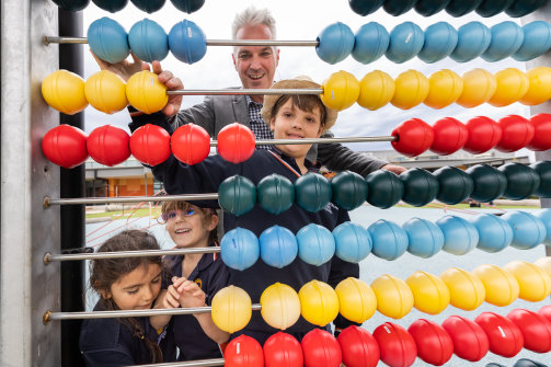 Armstrong Creek School principal Evan Savage with Eli, 10, Andina, 5, and Arianna, 6. 
