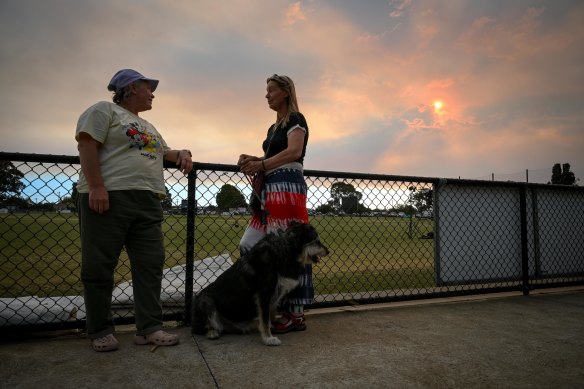 Tina Koeleman, Rebecca Brunner and their dog Chief outside the Wendouree emergency relief centre on Thursday night.