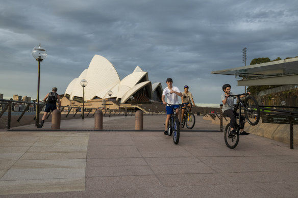 Bike riders take a spin around Circular Quay, which is usually filled with crowds.