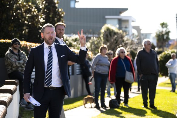 Auctioneer Ed Riley, of Riley Auctions, prepares to sell the Cabarita home for $4.72 million.