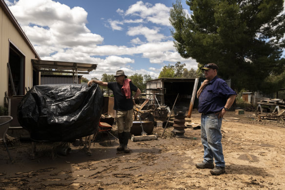 Eugowra locals Jack Barnes and Ron Hay clean up the men’s shed, where they host dozens of older men in town for coffee and conversations to help foster connection. All their equipment was destroyed in the flood.