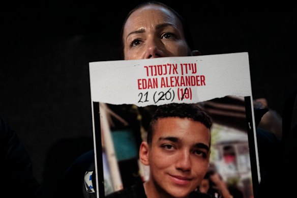 Yael Alexander holds a poster of her son, Edan, who was taken hostage by Hamas militants on October 7, 2023.