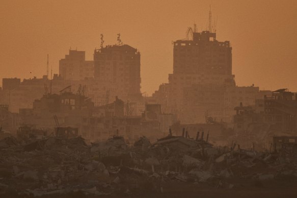 Buildings that were destroyed in the Israeli ground and air operations stand in the Gaza Strip during the sunset, as seen from southern Israel on Friday, September 5.