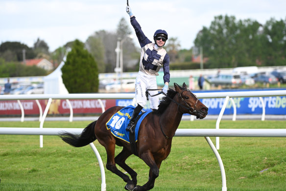 Harry Coffey rides Duke De Sessa to victory and celebrates after passing the post.