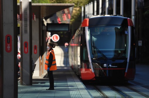 A light rail employee wearing a face mask in Sydney.