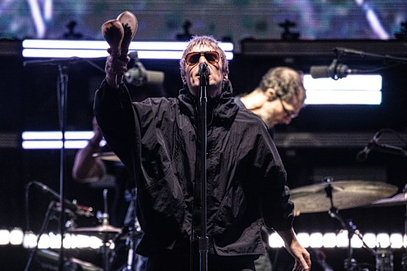 Liam Gallagher, all surly swagger in his zipped-up raincoat.