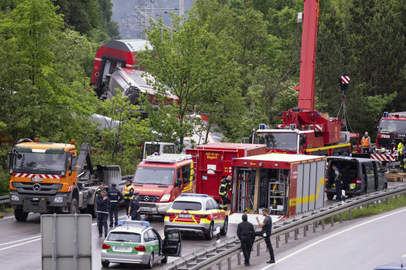 Emergency and rescue forces work on the site of a train crash.