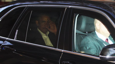Barack Obama is seen inside a motorcade in Sydney.