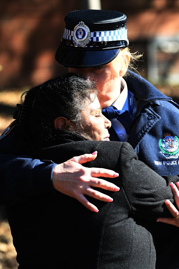 Julie Szabo is comforted by police officer Angela Cook after speaking to the media during an appeal for information into her son's death.