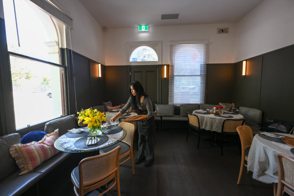 Muli’s tiny black-walled dining room has five tables, all round.