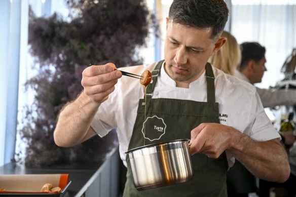 Gareth Whitton of Tarts Anon puts the finishing touches to his treat at the Lexus marquee.