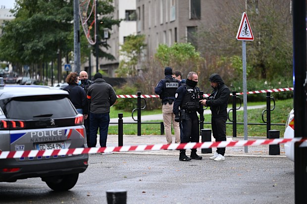 Police stand near a park after a shooting left one person dead and four others wounded in Trappes, outside Paris, Friday, Oct. 23, 2026. (AP Photo/Emma Da Silva)