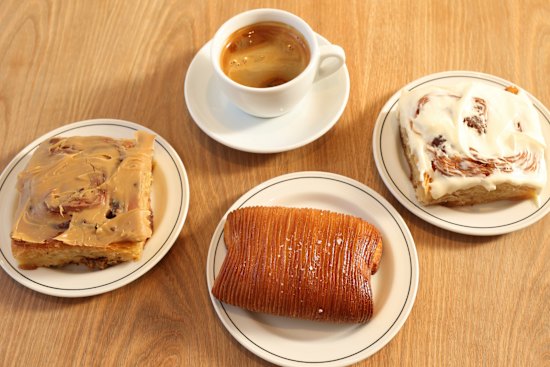 Coffee and baked goods at Hector’s Bakery, including the cinnamon bun with “Cinnabon vibes”(right).